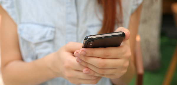 Woman using phone for telehealth visit